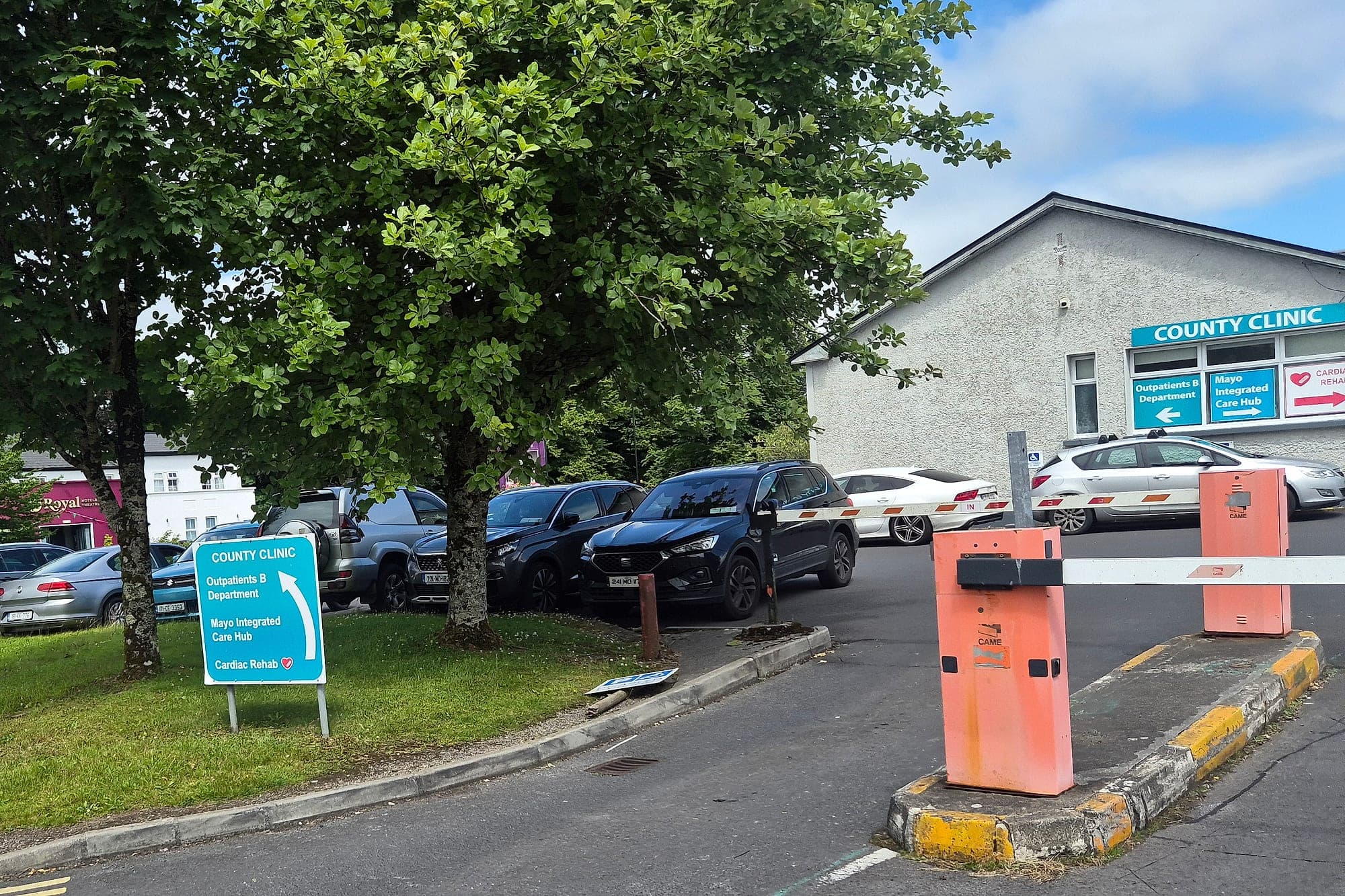 Accessibility audit site survey at Mayo University Hospital: layered directional and building identification signage at the County Clinic car park entrance