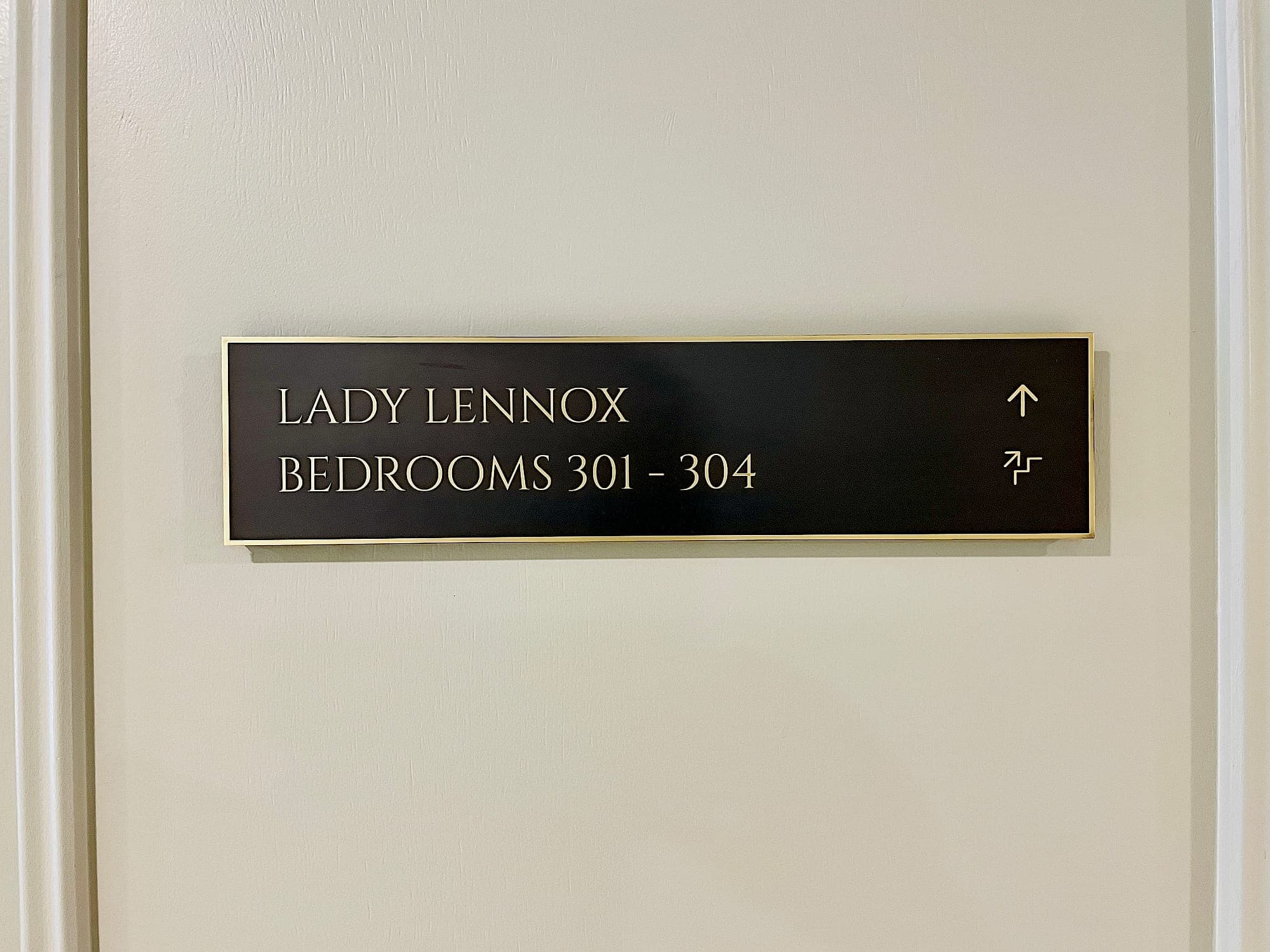 Engraved brass and bronze directional sign at Carton House reading Lady Lennox, Bedrooms 301-304, with arrow and stair pictogram