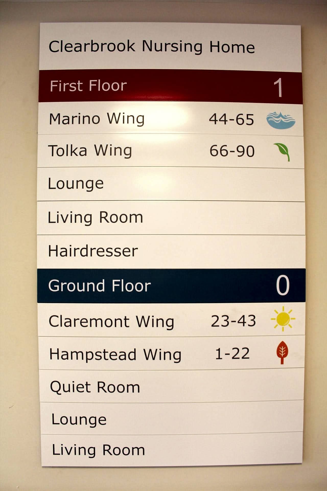 Building directory at Clearbrook Nursing Home listing named wings (Marino, Tolka, Claremont and Hampstead) with room number ranges and landmark symbols for each floor