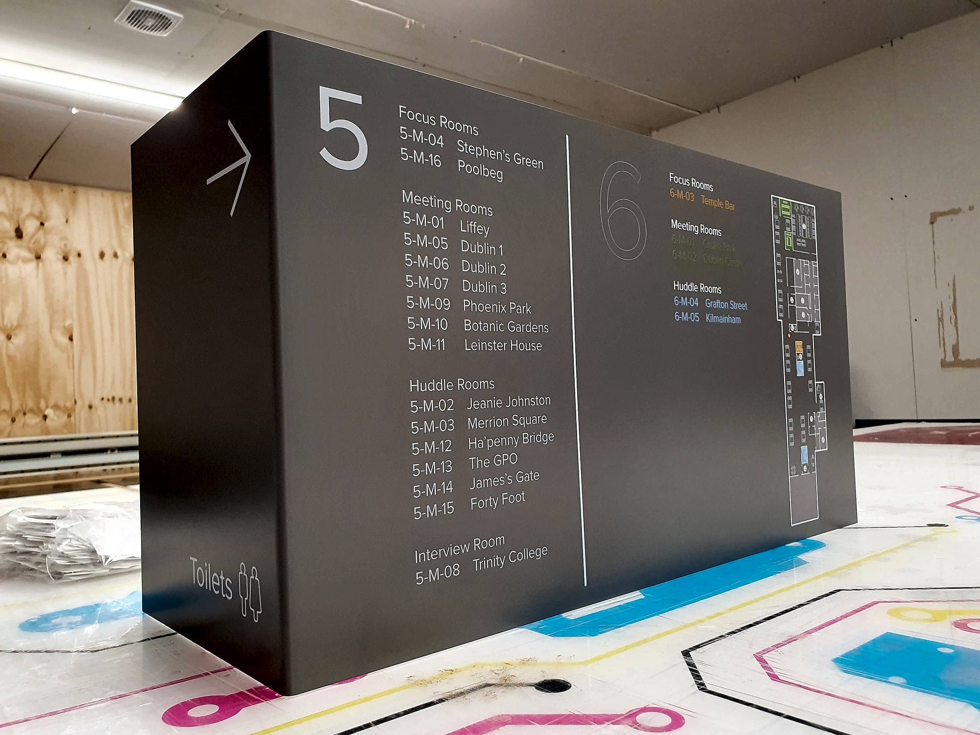 Gilead. Signage certification at the point of manufacture: a large floor directory panel checked in the workshop before delivery, listing meeting rooms by level
