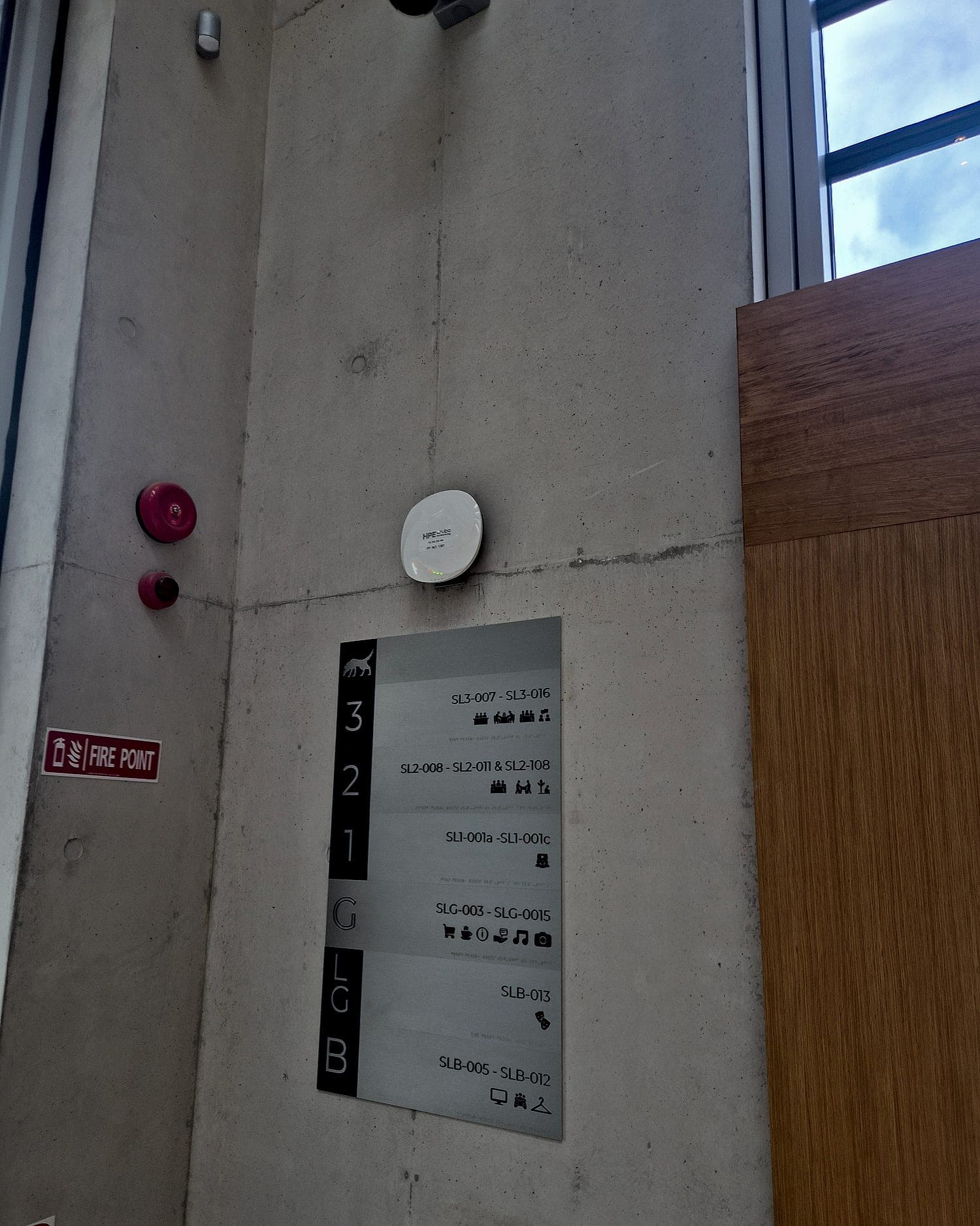 Static floor directory at the University of Limerick Student Union, in a concrete stair lobby: six levels from basement to third, each against a range of room codes with pictograms for the facilities on that floor