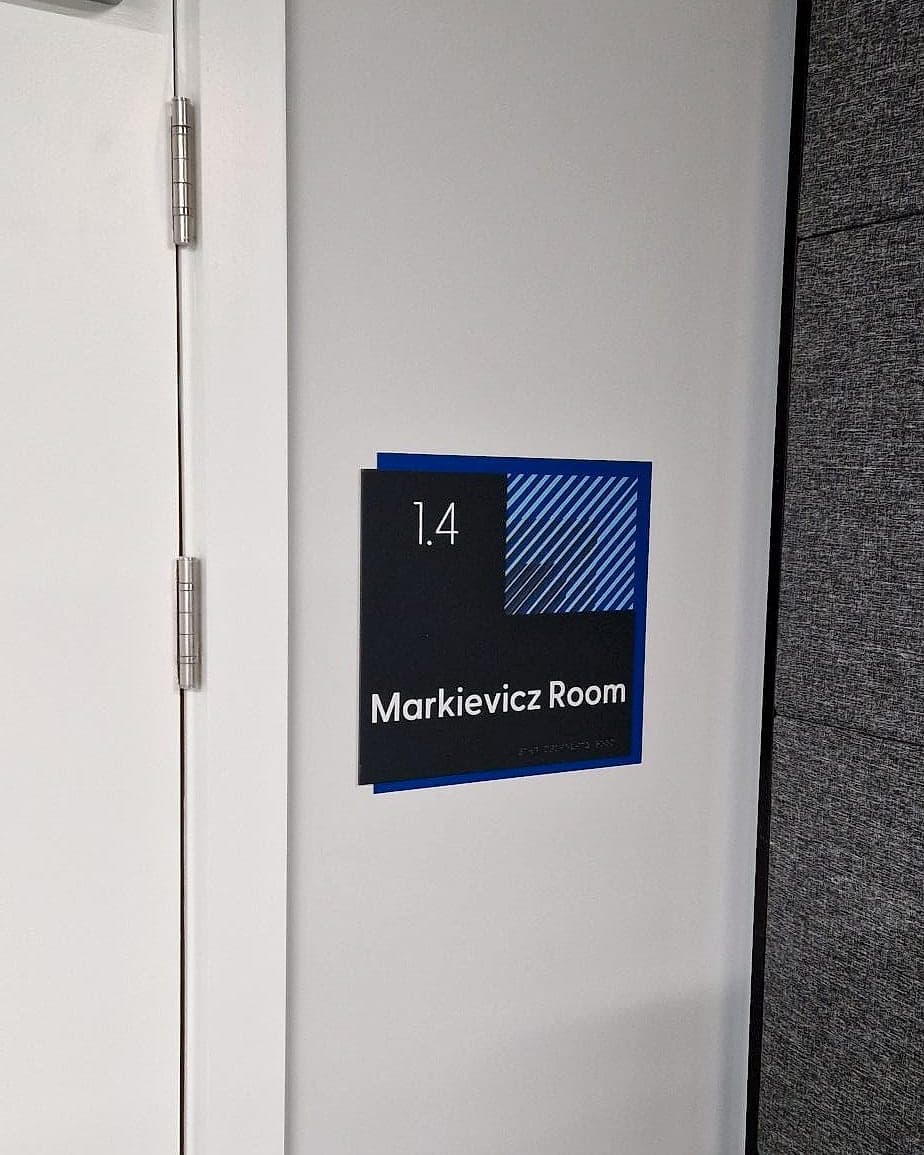 Certified accessible door sign at CCT College Dublin: room number, mixed-case room name and braille on a high-contrast tactile panel beside the door